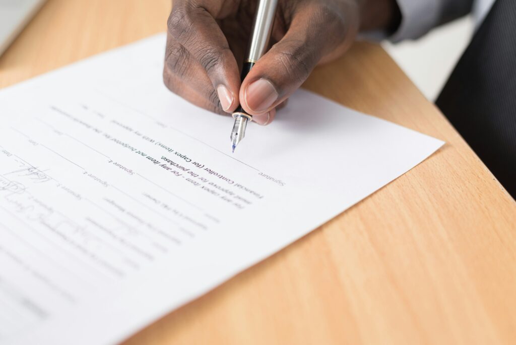 What to expect at first psychiatric visit - patient completing intake paperwork form with pen during psychiatric appointment