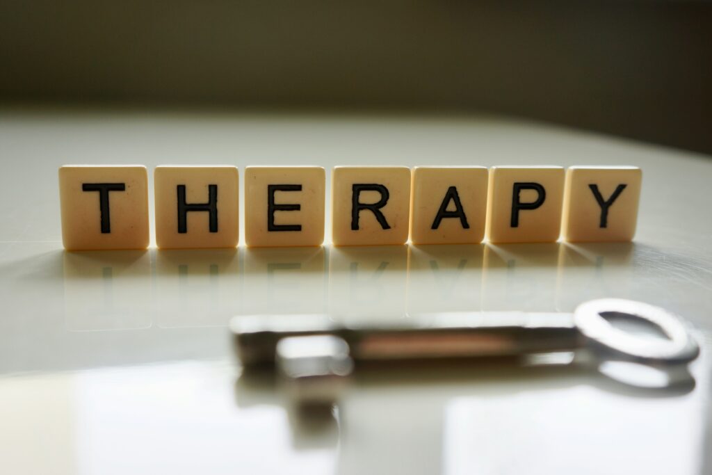 A row of Scrabble tiles spelling out 'APY' next to a stethoscope.