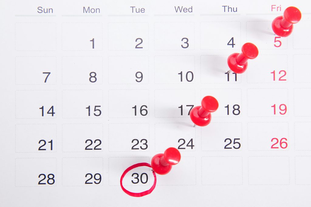 Calendar page marked with red pushpins highlighting specific urgent dates showing can l get same day psychiatric appointment in McKinney