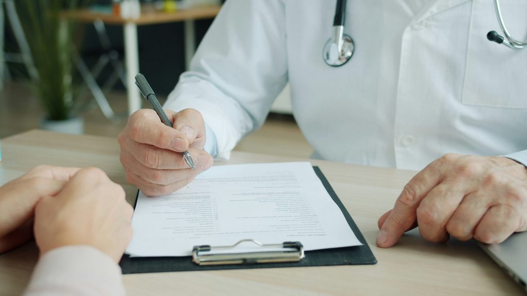Here is an SEO-friendly alt text option for your image that includes your primary keyword naturally:
Alternative Text:
Patient filling out paperwork for a same-day psychiatric appointment in McKinney at Harmonyville