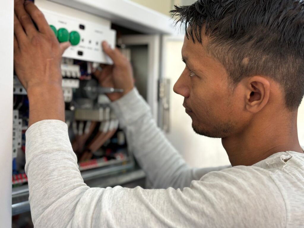 Electrician working on a circuit breaker panel, one of the best low-stress jobs for veterans with PTSD